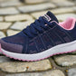 Navy and pink women's breathable mesh sneakers, designed for comfort and performance. Ideal for running or casual wear, with a lightweight and supportive structure.