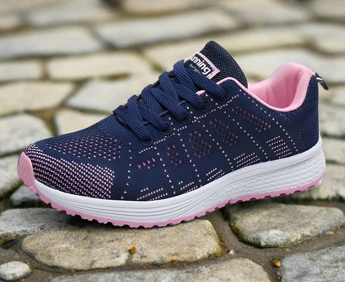 Navy and pink women's breathable mesh sneakers, designed for comfort and performance. Ideal for running or casual wear, with a lightweight and supportive structure.