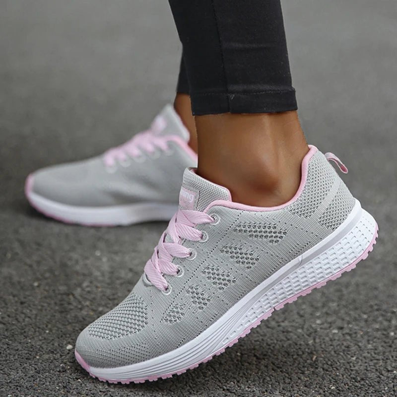 These gray breathable mesh sneakers with pink accents offer a perfect balance of comfort and style. Lightweight and versatile, they're ideal for both casual wear and active use.