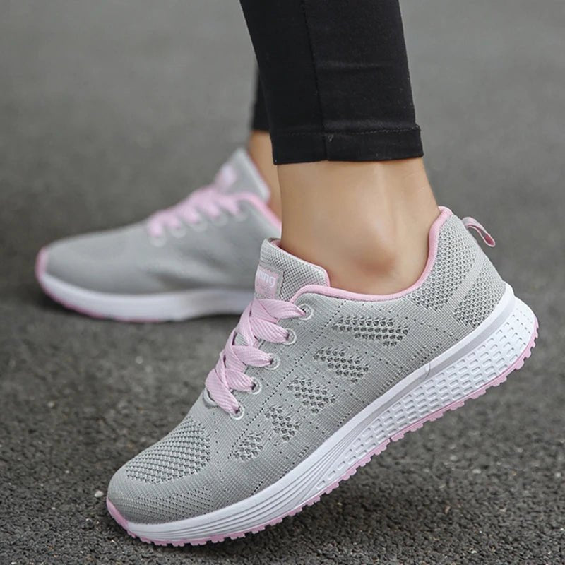 Women's breathable mesh sneakers with a stylish grey and pink design. These shoes provide comfort and durability for casual wear or workouts. Perfect for running or walking.