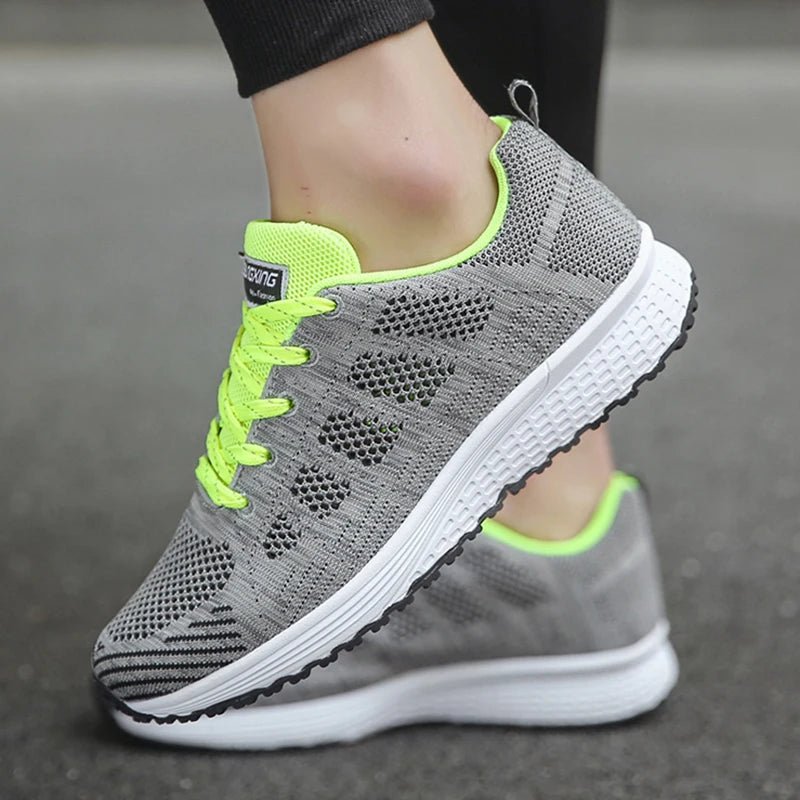 Women's breathable mesh sneakers in grey with neon green accents, offering superior ventilation and lightweight comfort. Perfect for running, walking, or casual outings.