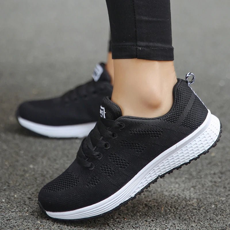 Women's black breathable mesh sneakers, featuring lightweight comfort and ventilation for running or casual wear. Ideal for all-day comfort, with a sleek and versatile design.