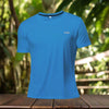 Light blue polyester running T-shirt with 'RUN' text, designed for breathability and performance, displayed in a natural outdoor setting.