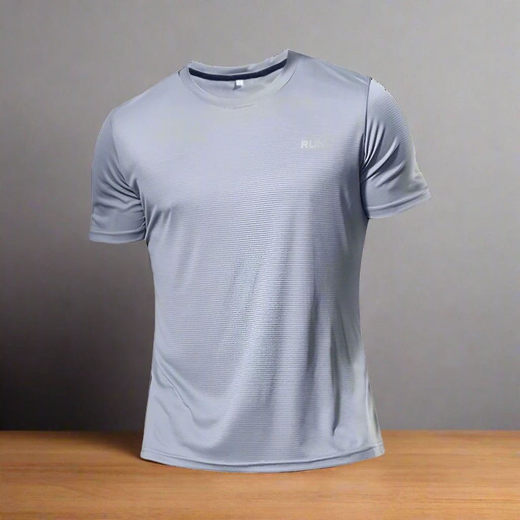 Light grey polyester running T-shirt with 'RUN' text, displayed on a wooden surface against a neutral background.