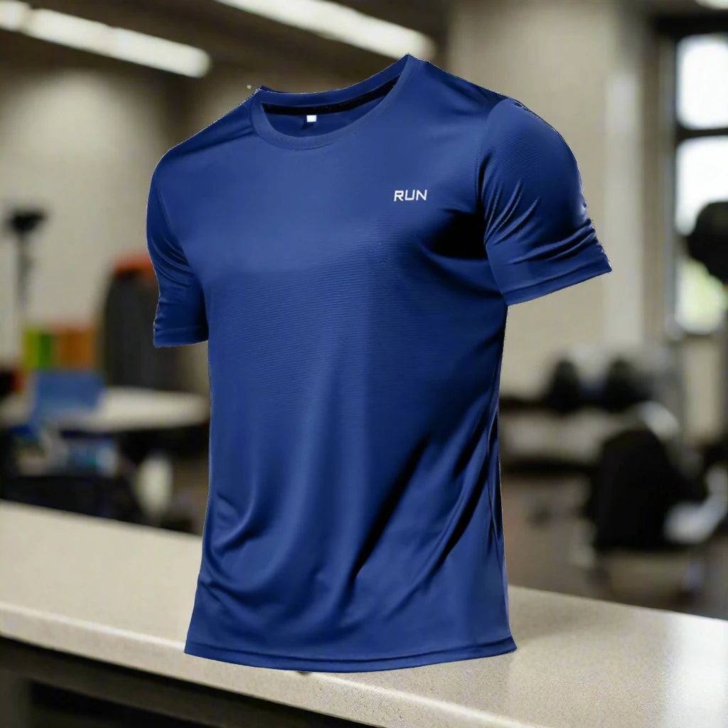 Blue polyester running T-shirt with 'RUN' text, showcased on a gym counter, creating a fitness-focused environment.