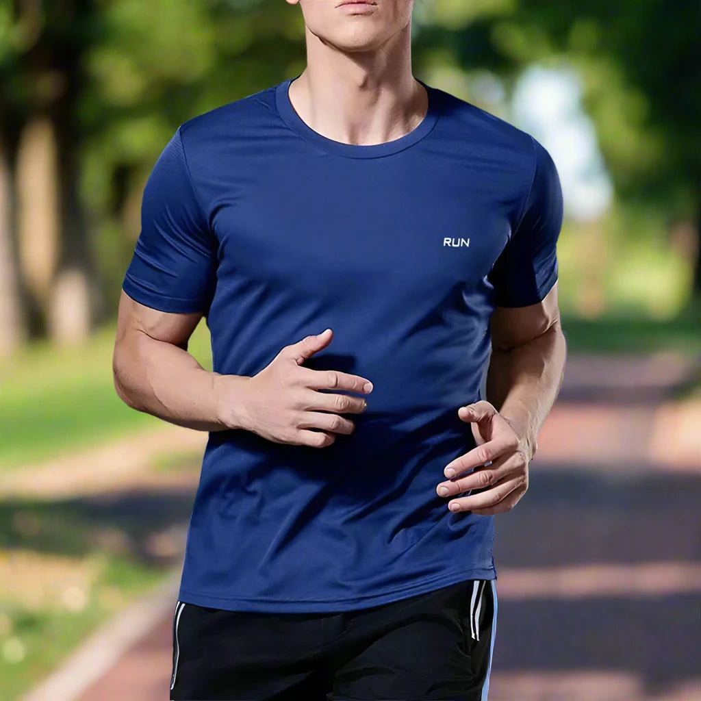 Man running outdoors in a navy blue, high-quality polyester T-shirt with a small 'RUN' logo, designed for comfort and breathability during exercise.