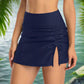 Navy blue ruched swim skirt with a side tie detail and slit, offering a stylish and adjustable fit for beachwear or poolside lounging.