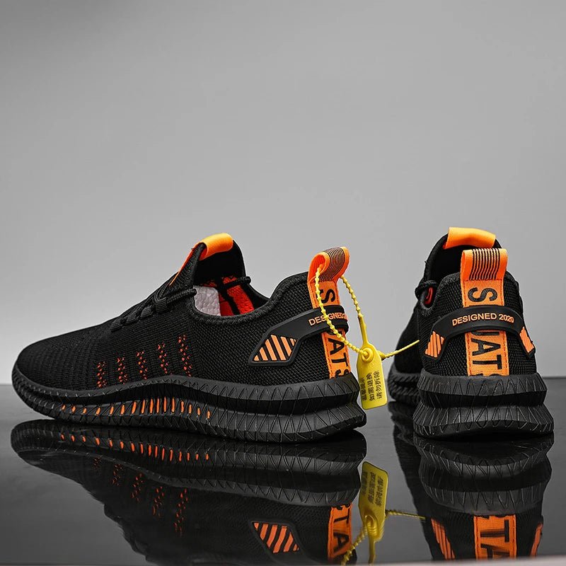 Back and side view of black and orange lightweight men's running shoes with a breathable mesh upper and reflective details, showcasing the design and flexibility of the shoes on a reflective surface.