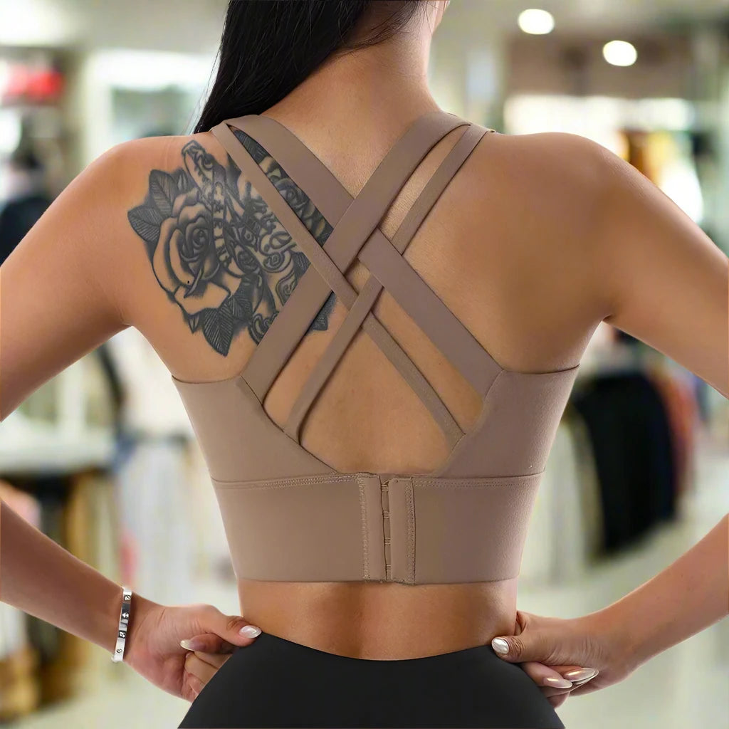 This image displays a beige sports push-up bra with a crisscross strap design at the back. The supportive and fashionable design is perfect for high-impact workouts or casual wear.







