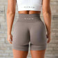 These grey high-waisted fitness shorts offer a seamless, comfortable fit, designed to enhance flexibility and support during workouts or casual wear, perfect for any activity.